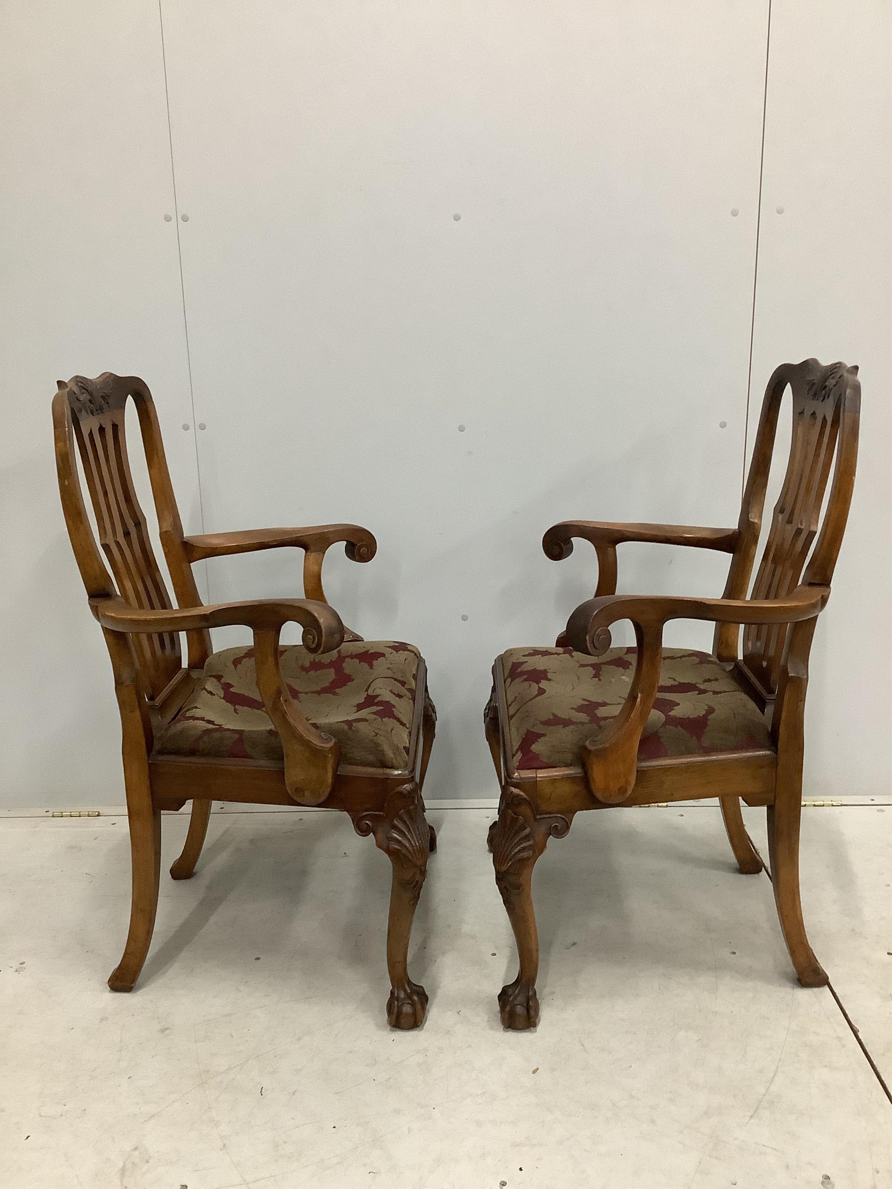 A set of eight George II style mahogany dining chairs on cabriole legs and ball and claw feet, two with arms. Condition - fair